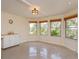 Bright living room featuring many windows with natural light, and a charming accent cabinet on wheels at 36408 E Eldorado Lake Dr, Eustis, FL 32736