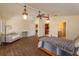 Open bedroom with hardwood floors and abundant natural light, also showcasing access to an adjacent walk-in closet at 36408 E Eldorado Lake Dr, Eustis, FL 32736