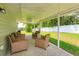 Covered patio with comfortable seating area, perfect for outdoor relaxation and entertaining at 36408 E Eldorado Lake Dr, Eustis, FL 32736