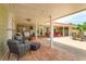 Expansive covered patio with outdoor kitchen, dining and lounge areas, brick pavers at 36408 E Eldorado Lake Dr, Eustis, FL 32736
