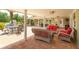 Spacious covered patio with brick pavers, comfortable seating, and outdoor dining area at 36408 E Eldorado Lake Dr, Eustis, FL 32736
