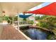 Outdoor patio area featuring a bridge over a pond, perfect for entertaining at 36408 E Eldorado Lake Dr, Eustis, FL 32736