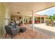Extensive outdoor patio area featuring multiple seating zones, including a built-in kitchen and dining space at 36408 E Eldorado Lake Dr, Eustis, FL 32736