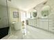 Spa-like bathroom with a modern soaking tub, glass enclosed shower, and double sink vanity at 405 Bella Vida Blvd, Orlando, FL 32828
