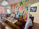 Spacious dining room featuring unique wall art, stylish chandelier, and hardwood floors at 405 Bella Vida Blvd, Orlando, FL 32828