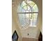 Bright foyer showcasing a modern chandelier and arched window above the front door at 405 Bella Vida Blvd, Orlando, FL 32828