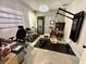 Home gym featuring workout equipment, a mounted TV, desk area and chandelier lighting at 405 Bella Vida Blvd, Orlando, FL 32828