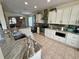 Modern kitchen with granite countertops, white cabinets, stainless steel appliances, and an island at 405 Bella Vida Blvd, Orlando, FL 32828