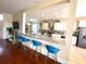 Eat-in kitchen featuring a marble countertop island with seating, stainless steel appliances, and pendant lighting at 405 Bella Vida Blvd, Orlando, FL 32828