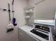 Functional laundry room with washer, dryer, shelving and storage space at 405 Bella Vida Blvd, Orlando, FL 32828