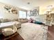 Spacious living room featuring a sectional sofa and multiple prints on the wall at 405 Bella Vida Blvd, Orlando, FL 32828