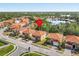 An aerial view of the homes with red-tiled roofs and a serene lake in the background at 411 Cabello Dr, Davenport, FL 33837