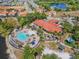 Aerial view of a resort style pool and recreational area with seating, landscaping, and turquoise water features at 411 Cabello Dr, Davenport, FL 33837