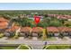 Aerial view of a property with a beautiful pond view in a community with tile roofs and lush landscaping at 411 Cabello Dr, Davenport, FL 33837