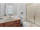 Bathroom features a sink, toilet and a shower with glass doors at 411 Cabello Dr, Davenport, FL 33837