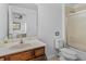 Bathroom featuring a vanity, toilet, and shower with glass doors at 411 Cabello Dr, Davenport, FL 33837