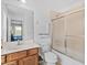 Bathroom vanity with marble countertop, shower with glass door, and an open view to the bedroom at 411 Cabello Dr, Davenport, FL 33837