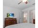 This bedroom is spacious and includes a large dresser with TV at 411 Cabello Dr, Davenport, FL 33837