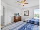 Bright bedroom with two twin beds, dresser with TV and white walls at 411 Cabello Dr, Davenport, FL 33837