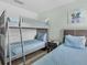 Bedroom featuring bunkbeds and coordinated blue bedding at 411 Cabello Dr, Davenport, FL 33837