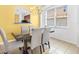 Bright dining space with a glass-topped table, chandelier, and natural light from a large window at 411 Cabello Dr, Davenport, FL 33837