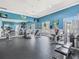 A fully-equipped gym with modern exercise machines, wall mirrors, and ample natural light at 411 Cabello Dr, Davenport, FL 33837