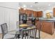 Eat-in kitchen area featuring a glass table, tile floors, and wooden cabinets, adjoining seamlessly with the kitchen space at 411 Cabello Dr, Davenport, FL 33837