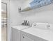 Bright laundry room with white appliances and shelving, accessible from garage, offering convenience at 411 Cabello Dr, Davenport, FL 33837