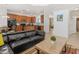 Open-concept living space with tile flooring, wooden cabinetry, and seamless flow between the kitchen and living areas at 411 Cabello Dr, Davenport, FL 33837