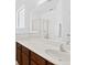 Bathroom vanity with a large frameless mirror, solid surface countertop and a clear shower at 411 Cabello Dr, Davenport, FL 33837