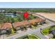 A lovely residential neighborhood with orange-tiled roofs, palm trees, and proximity to a pond and green spaces at 411 Cabello Dr, Davenport, FL 33837