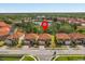 Street view of the homes with tile roofs, well-maintained lawns, and community lake view at 411 Cabello Dr, Davenport, FL 33837
