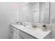 Bathroom featuring double sinks, quartz countertops, framed mirror, and neutral decor at 4351 Finch Ln, Kissimmee, FL 34746