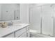 Bright bathroom features a shower with glass doors, vanity, and white quartz countertop at 4351 Finch Ln, Kissimmee, FL 34746