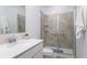 Bathroom featuring a glass-enclosed shower, modern fixtures, and a white vanity at 4351 Finch Ln, Kissimmee, FL 34746