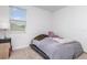 Simply decorated bedroom with carpet and a large window allowing natural light at 4351 Finch Ln, Kissimmee, FL 34746