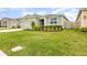 Charming one-story home featuring a well-manicured lawn and a neatly landscaped garden bed at 4351 Finch Ln, Kissimmee, FL 34746
