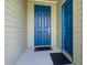 Inviting front entrance featuring a bright blue front door and a secondary side door at 4351 Finch Ln, Kissimmee, FL 34746
