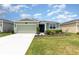 Charming single-story home with a well-manicured lawn and a two-car garage at 4351 Finch Ln, Kissimmee, FL 34746