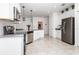 Open concept kitchen with stainless steel appliances, white cabinets, and modern pendant lighting at 4351 Finch Ln, Kissimmee, FL 34746