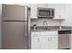 Modern kitchen featuring stainless steel appliances, white cabinets, and gray countertops at 4351 Finch Ln, Kissimmee, FL 34746
