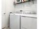 Practical laundry room equipped with a washer, dryer, and overhead storage shelf at 4351 Finch Ln, Kissimmee, FL 34746
