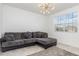 Bright living room showing tile floor, large window and a comfortable grey couch with decorative pillows at 4351 Finch Ln, Kissimmee, FL 34746