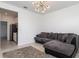 The living room is equipped with modern lighting and an oversized grey couch with many pillows at 4351 Finch Ln, Kissimmee, FL 34746