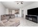 Open living space with tile flooring, recessed lighting, and a view of the adjacent kitchen at 4351 Finch Ln, Kissimmee, FL 34746