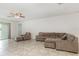 Spacious living room with neutral colors, tile floors, and a ceiling fan at 4351 Finch Ln, Kissimmee, FL 34746