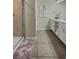 Modern bathroom featuring a double vanity and glass shower at 4751 Clock Tower Dr # 103, Kissimmee, FL 34746