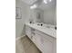 Modern bathroom featuring double sinks with white cabinets and elegant tile flooring at 4751 Clock Tower Dr # 103, Kissimmee, FL 34746