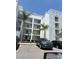 Modern condo building with multiple stories, balconies, and parking spaces for residents and visitors at 4751 Clock Tower Dr # 103, Kissimmee, FL 34746