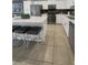 Spacious kitchen with an island, sleek appliances, and ample counter space at 4751 Clock Tower Dr # 103, Kissimmee, FL 34746